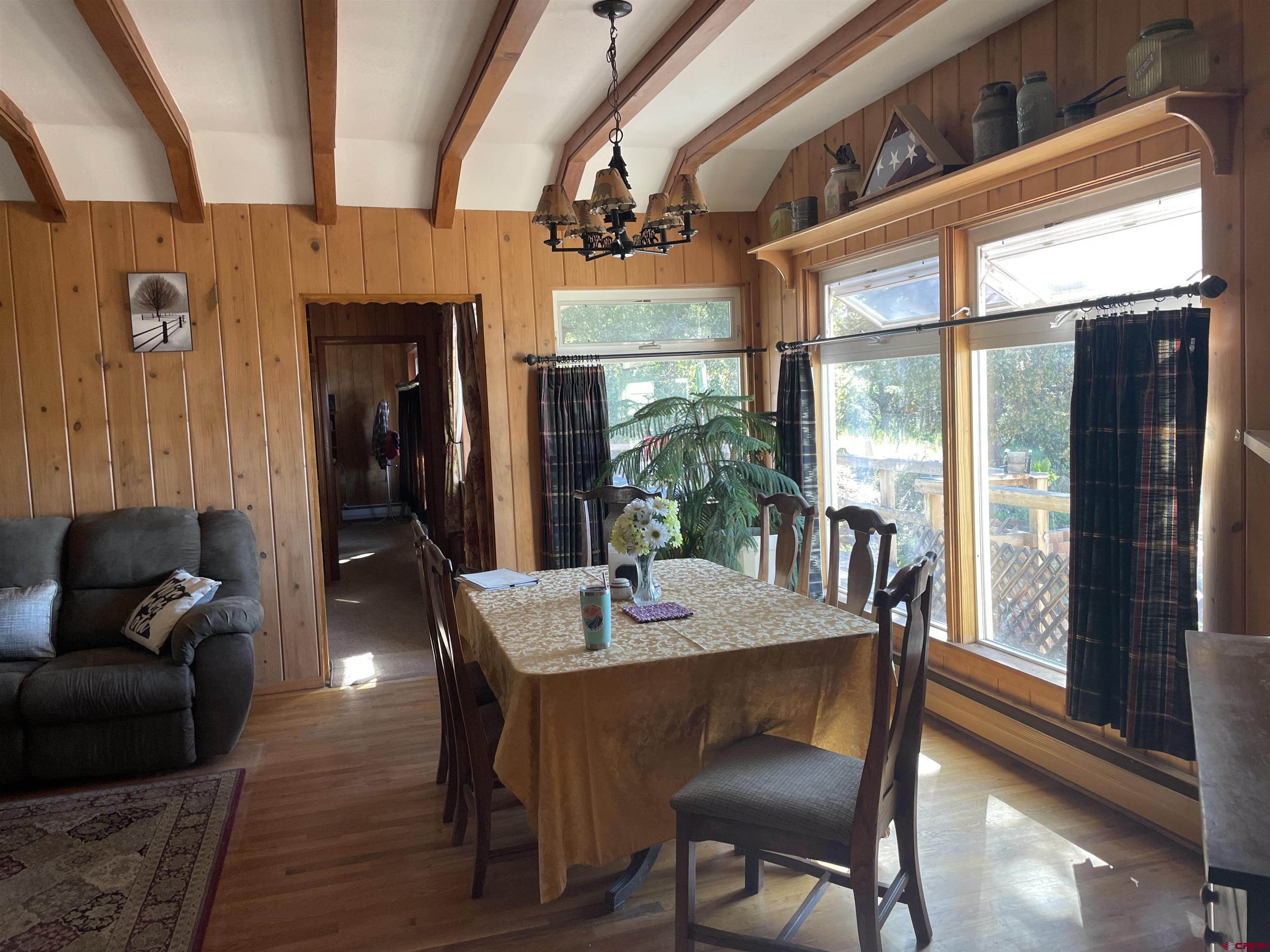 21439 2300th Road Cedaredge, CO 81413 - Photo 19 of 20 a dining room with furniture a chandelier and wooden floor