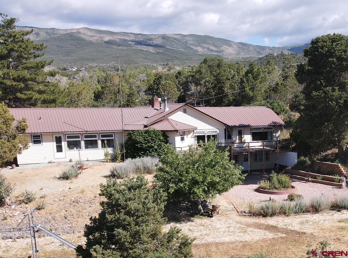 21439 2300th Road Cedaredge, CO 81413 - Photo 3 of 20 a view of a house with a garden