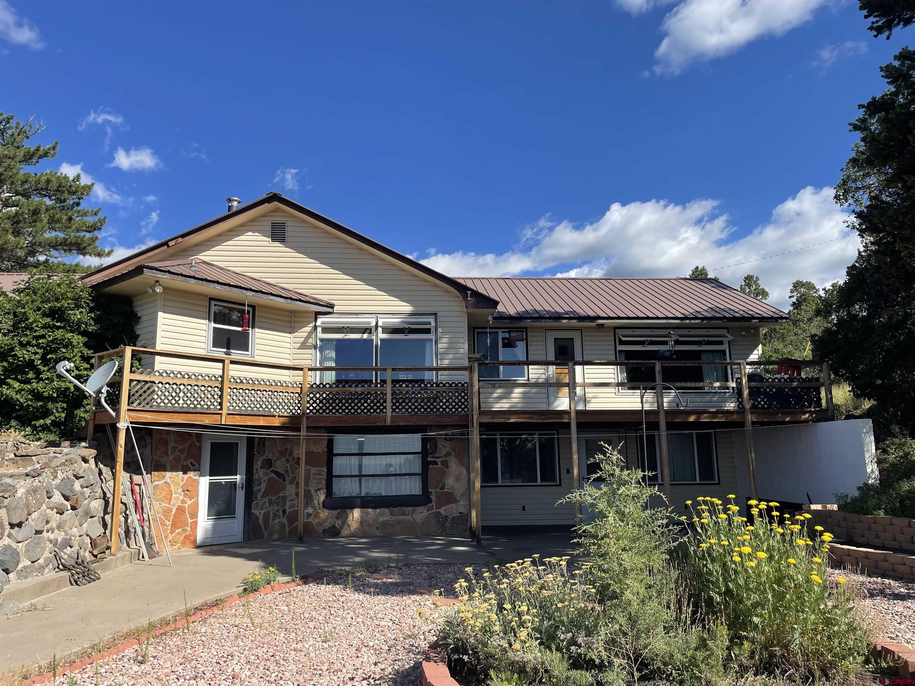 21439 2300th Road Cedaredge, CO 81413 - Photo 4 of 20 a front view of a house with garden