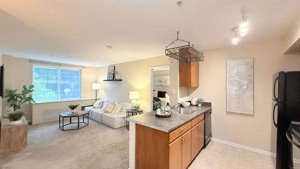 a room with a chandelier furniture and a large window