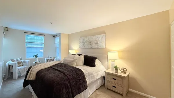 a bedroom with a bed and lamp