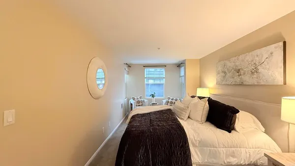 a bedroom with a bed and window