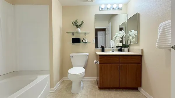 a bathroom with a sink a toilet and bathtub
