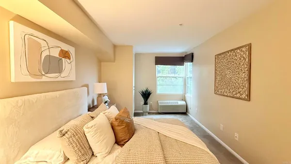 a bedroom with a bed couch and window