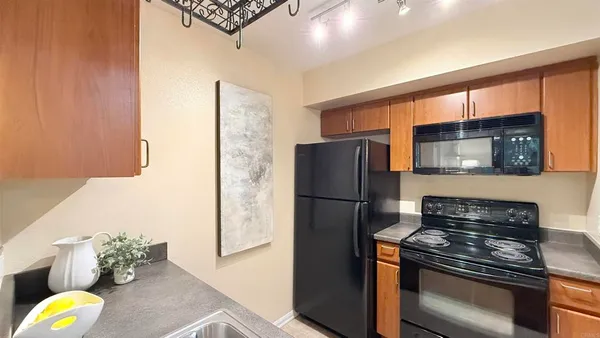 a kitchen with a refrigerator and a stove top oven