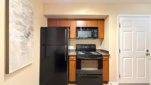 a kitchen with a refrigerator stove and microwave