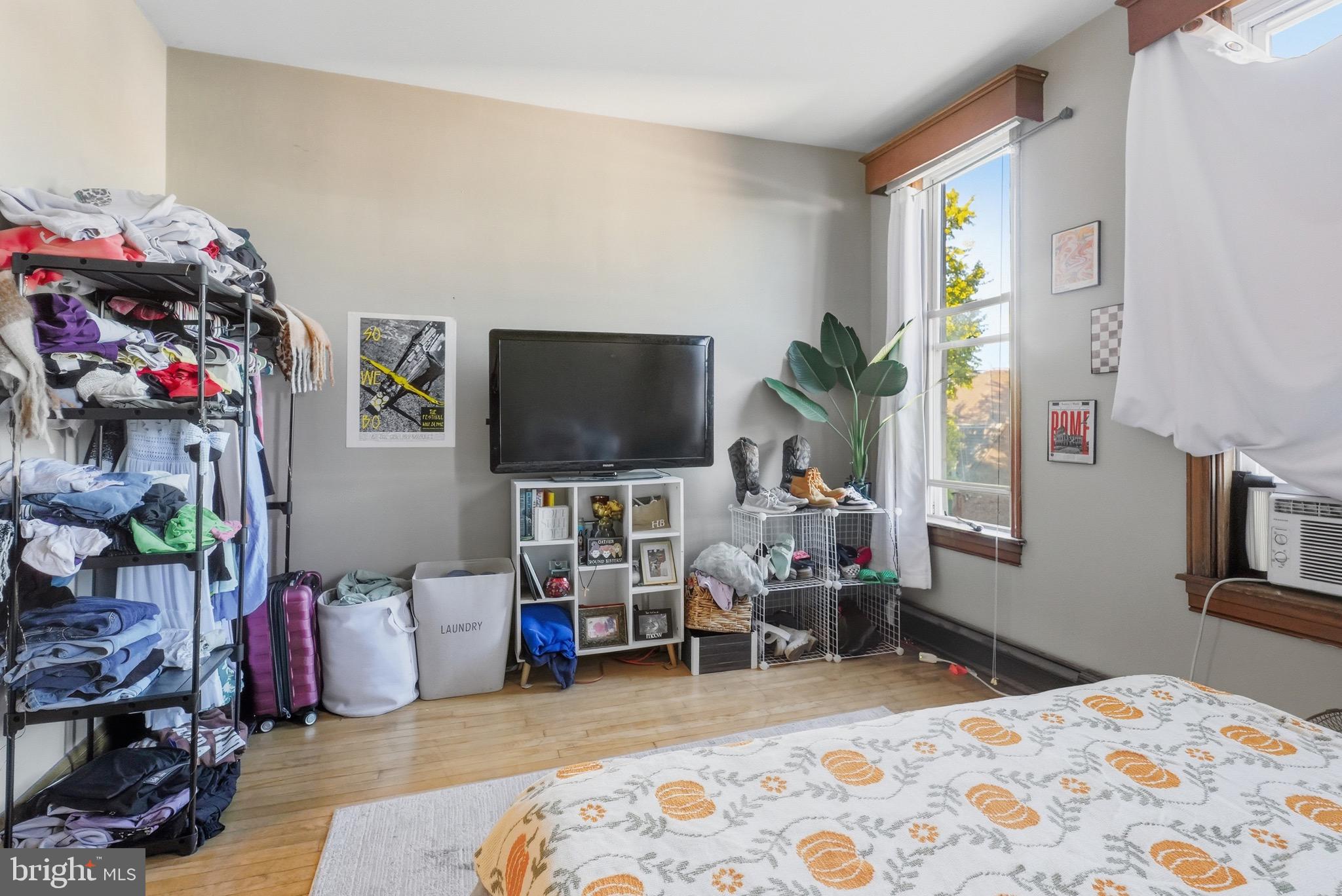 1412 Light Street, Unit 3 Baltimore, MD 21230 - Photo 11 of 23 a bedroom with furniture and a flat screen tv