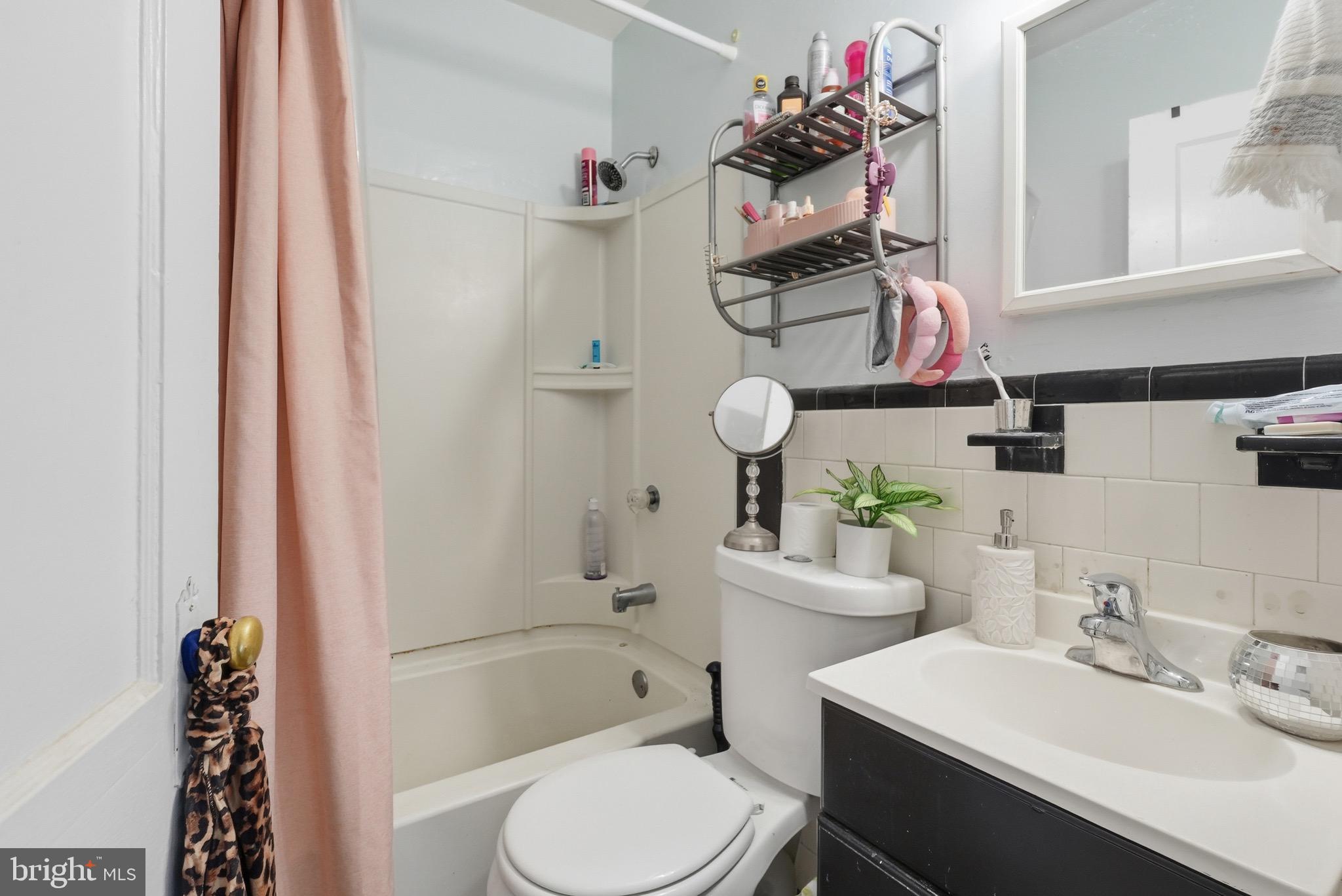 1412 Light Street, Unit 3 Baltimore, MD 21230 - Photo 12 of 23 a bathroom with a sink mirror vanity and toilet
