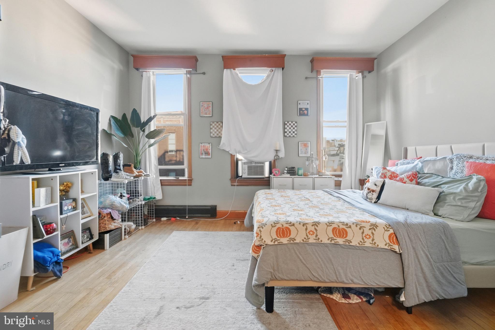 1412 Light Street, Unit 3 Baltimore, MD 21230 - Photo 15 of 23 a bedroom with a bed and flat screen tv