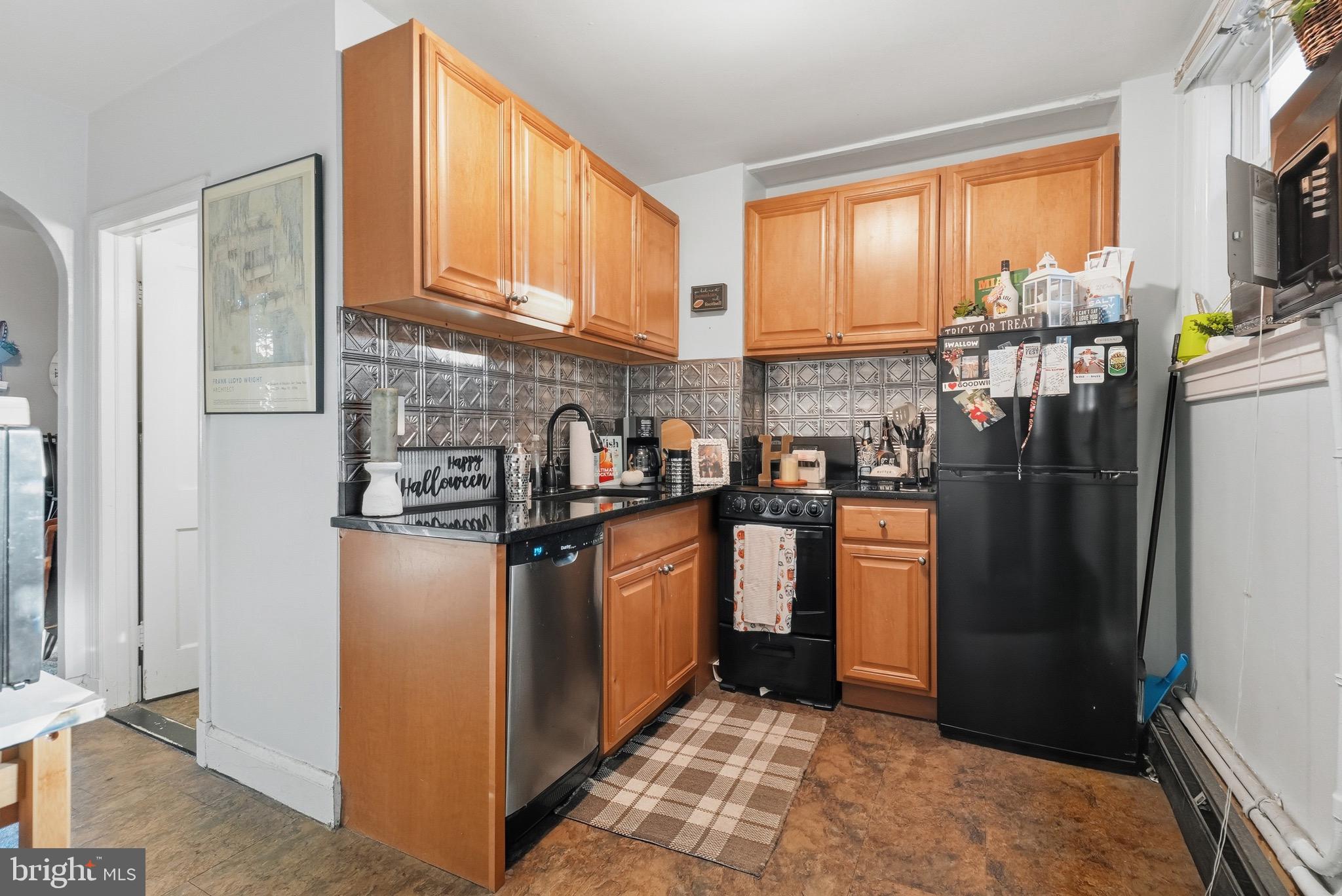 1412 Light Street, Unit 3 Baltimore, MD 21230 - Photo 4 of 23 a kitchen with stainless steel appliances granite countertop a refrigerator a stove top oven a sink and dishwasher
