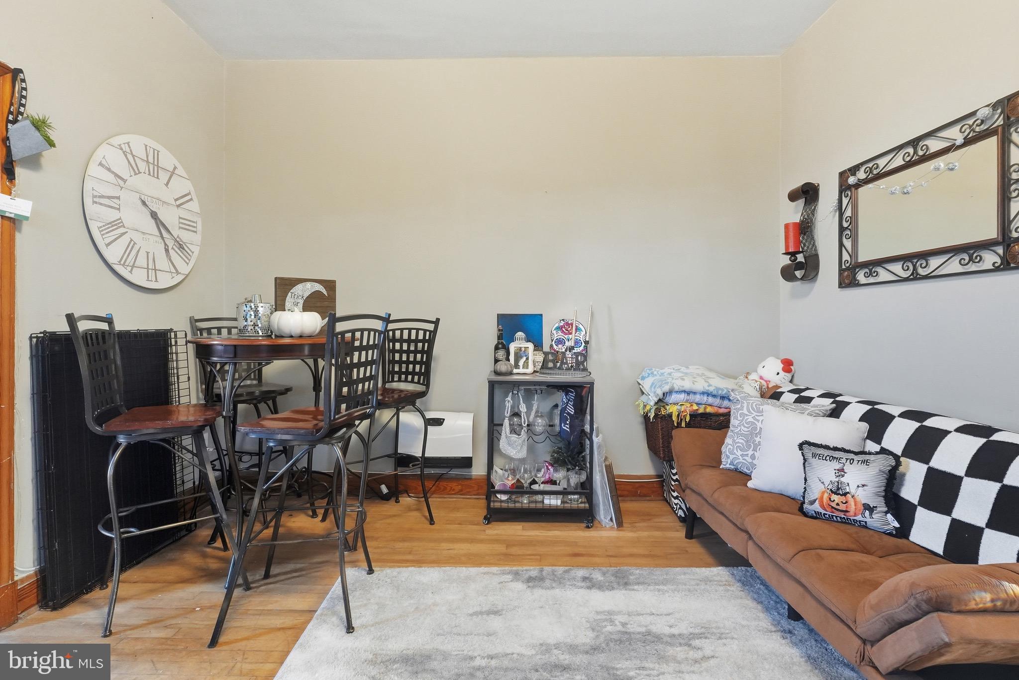 1412 Light Street, Unit 3 Baltimore, MD 21230 - Photo 8 of 23 a living room with furniture a flat screen tv and a table