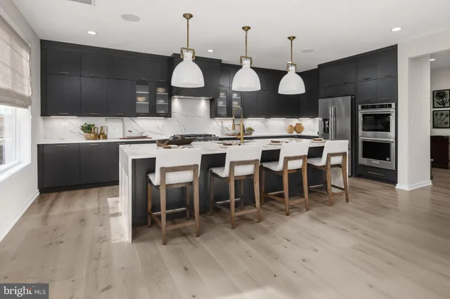 a large kitchen with a table and chairs