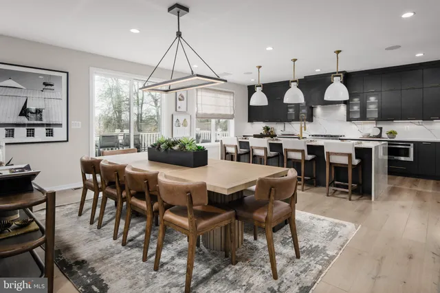 a dinning area with lots of furniture and kitchen view