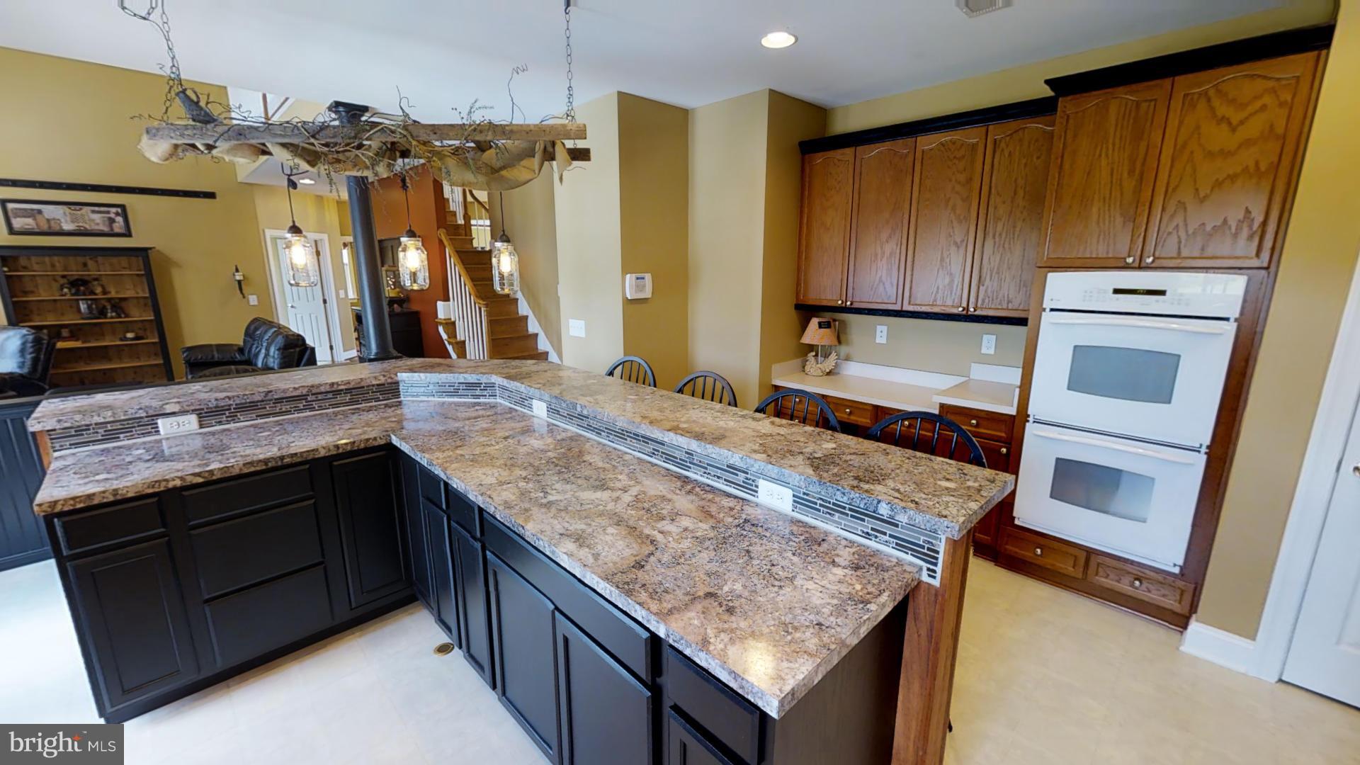 283 Rippling Waters Way Falling Waters, WV 25419 - Photo 11 of 30 a bathroom with a granite countertop sink and a wooden floor