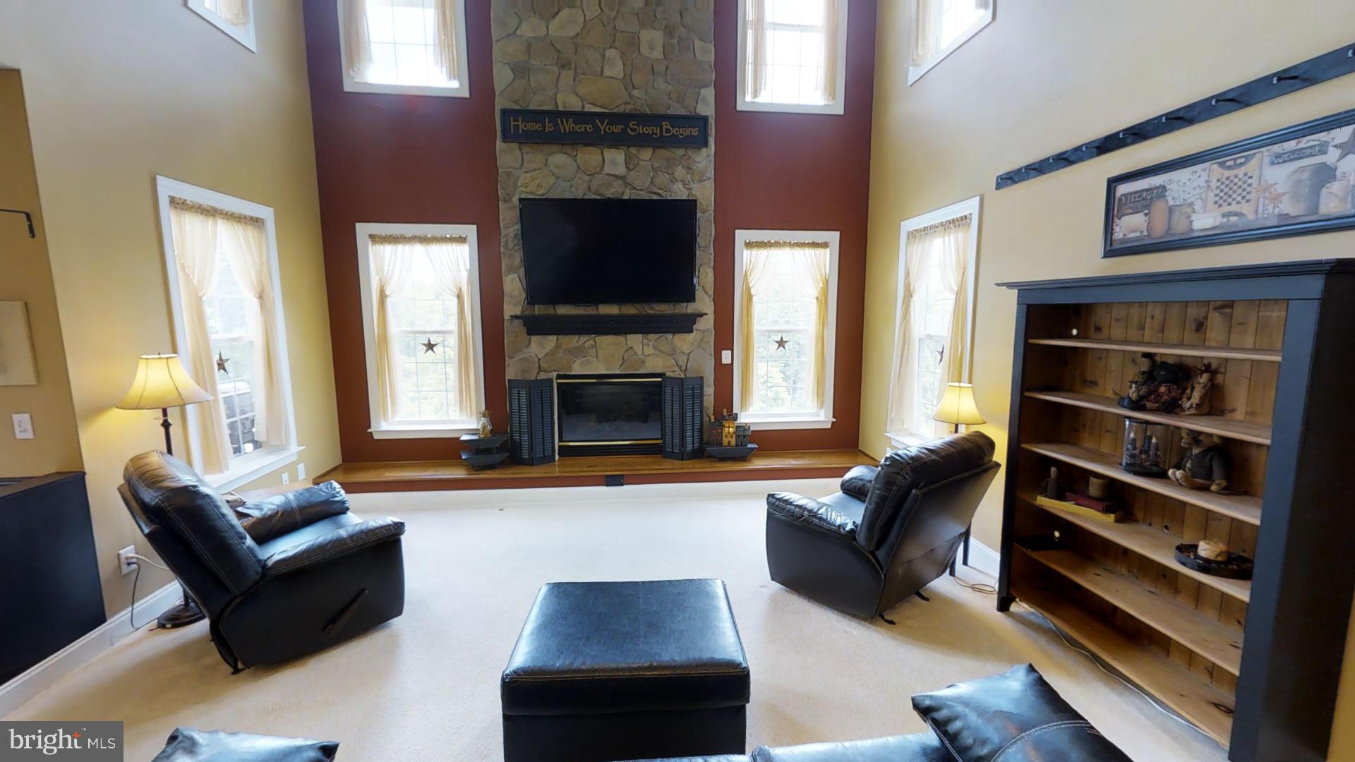 283 Rippling Waters Way Falling Waters, WV 25419 - Photo 14 of 30 a living room with furniture and a fireplace
