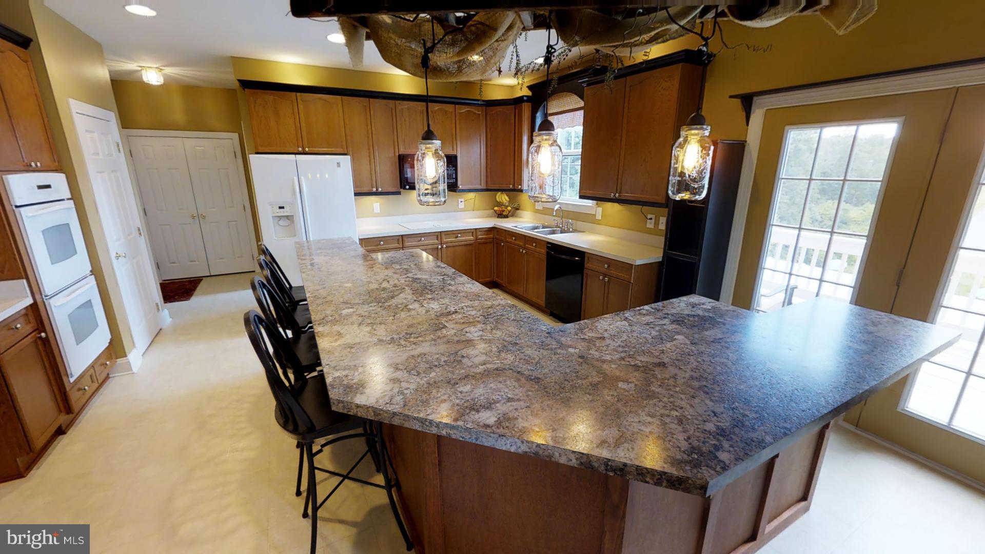 283 Rippling Waters Way Falling Waters, WV 25419 - Photo 10 of 30 a kitchen with stainless steel appliances granite countertop sink stove top oven and cabinets