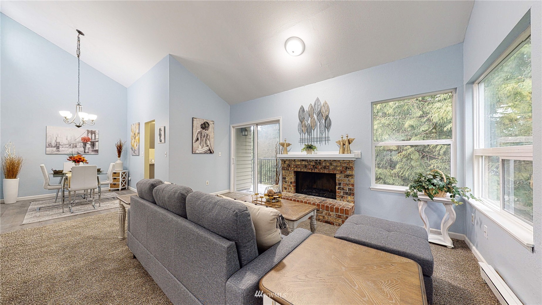 820 Cady Road, Unit C304 Everett, WA 98203 - Photo 6 of 23 a living room with furniture a chandelier and a fireplace