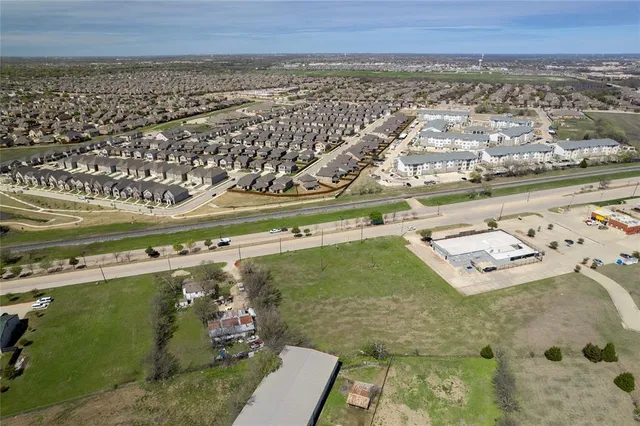 an aerial view of a residential building and an ocean view