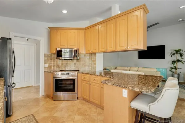 a kitchen with a stove a sink and a refrigerator