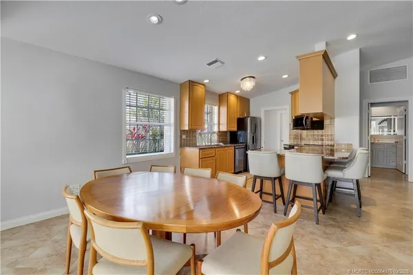 a view of a dining room with furniture and a large window
