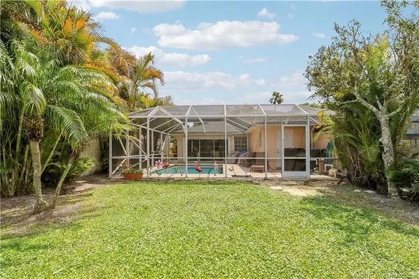 a view of a house with pool and sitting area