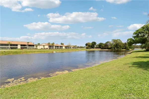 a view of a lake with houses in the back