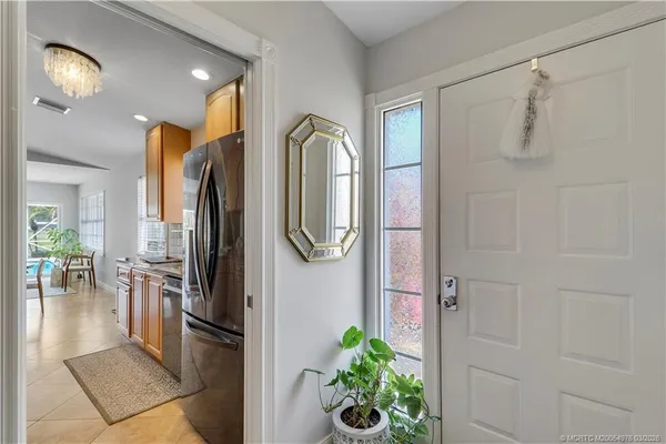 a kitchen with stainless steel appliances granite countertop a refrigerator a stove and a window