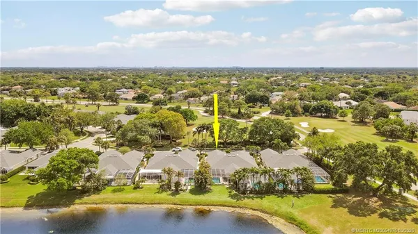 an aerial view of residential houses with yard