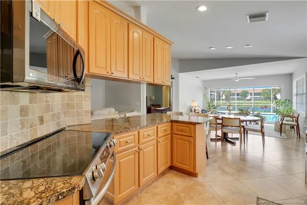 a kitchen with stainless steel appliances granite countertop sink microwave and stove top oven