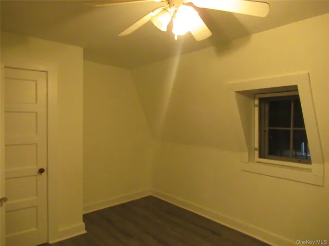 a view of a small space with wooden floor and a window