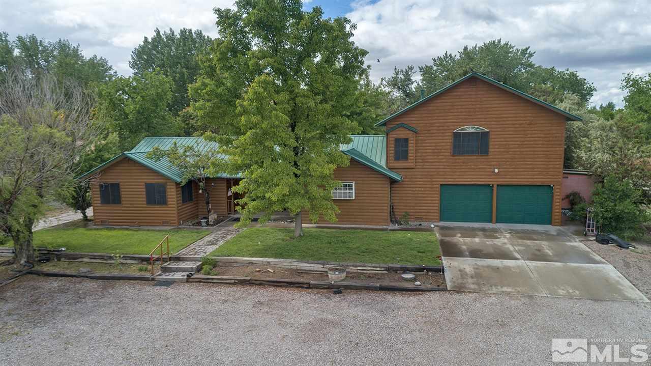 3318 Bottom Road Fallon, NV 89406 - Photo 1 of 23 a front view of a house with a yard and garage