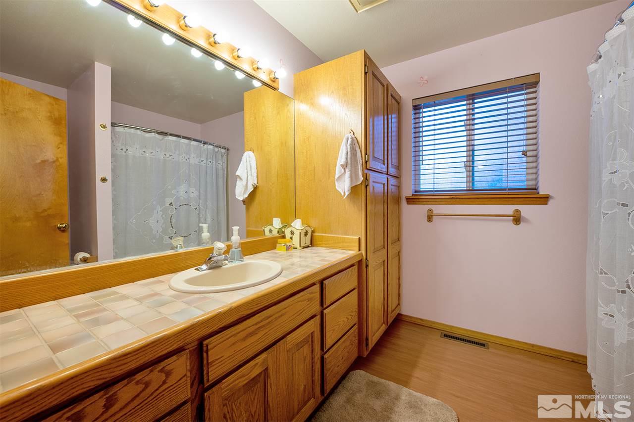 3318 Bottom Road Fallon, NV 89406 - Photo 13 of 23 a bathroom with a granite countertop sink and a mirror