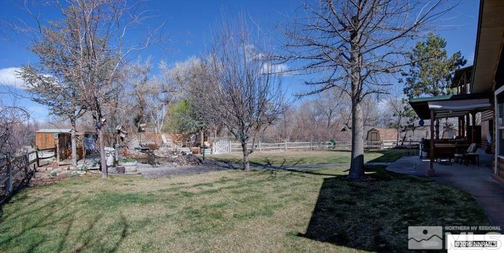 3318 Bottom Road Fallon, NV 89406 - Photo 16 of 23 a view of a backyard with table and chairs and potted plants