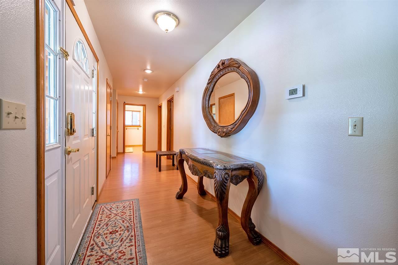 3318 Bottom Road Fallon, NV 89406 - Photo 2 of 23 a view of a hallway with wooden floor and workspace