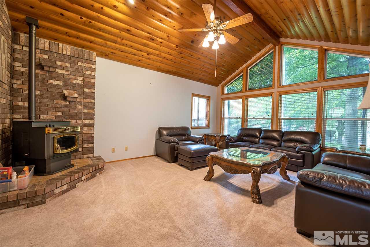 3318 Bottom Road Fallon, NV 89406 - Photo 3 of 23 a living room with furniture a flat screen tv and a fireplace