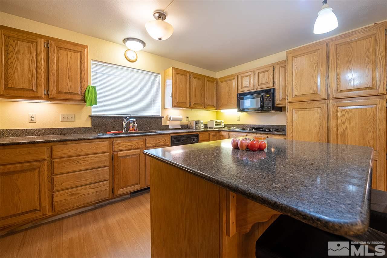 3318 Bottom Road Fallon, NV 89406 - Photo 6 of 23 a kitchen with stainless steel appliances granite countertop a sink stove and refrigerator