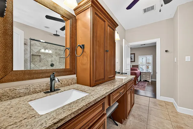 a kitchen with granite countertop a sink and cabinets