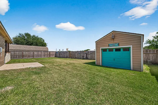 a view of an house with backyard space and trampoline