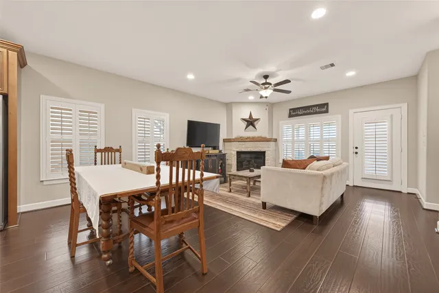 a living room with fireplace furniture and a wooden floor