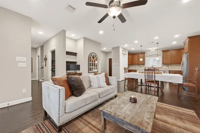 a living room with stainless steel appliances furniture and a view of kitchen