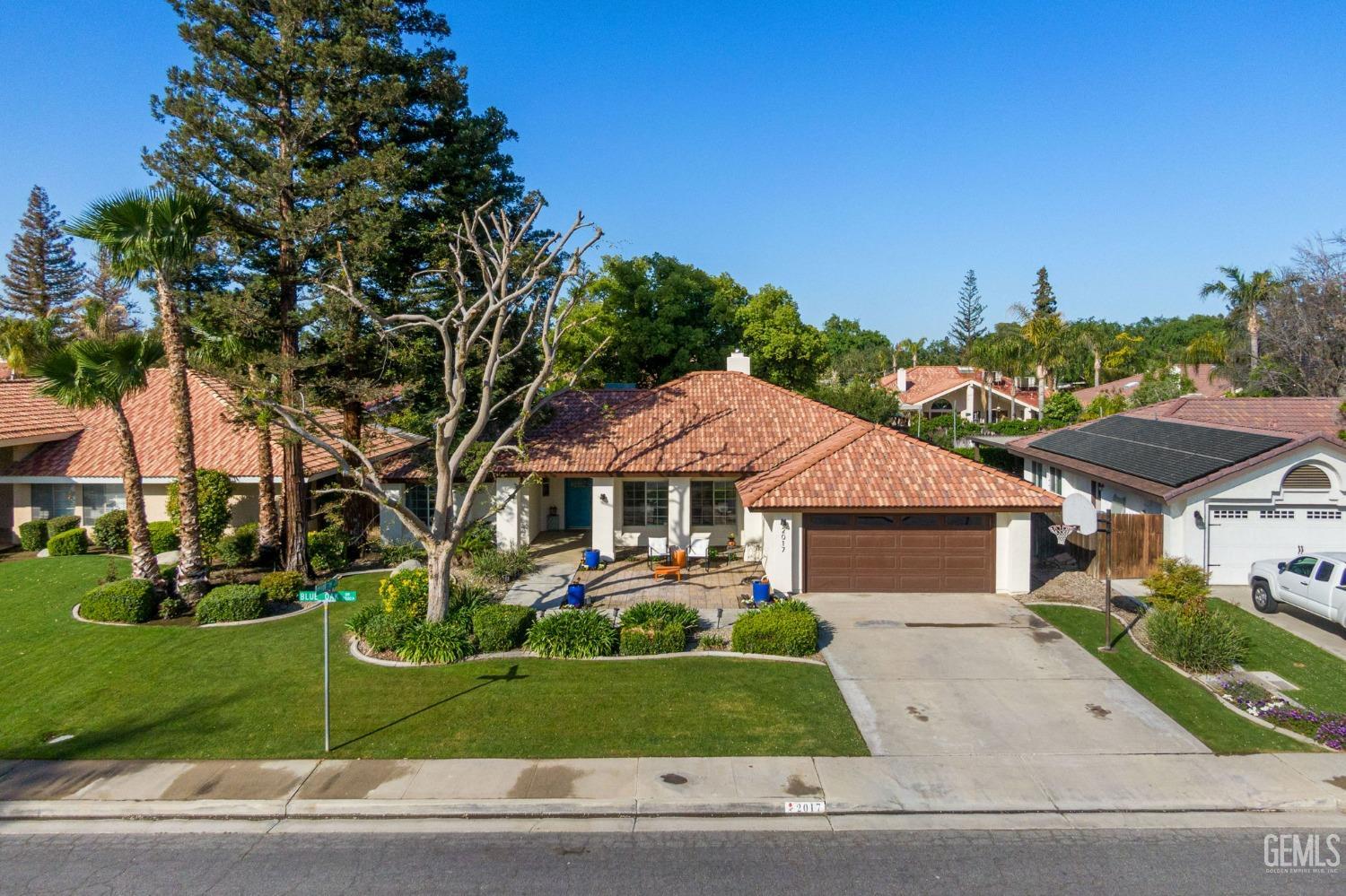 Undisclosed Address Bakersfield, CA 93311 - Photo 2 of 69 a front view of a house with a garden