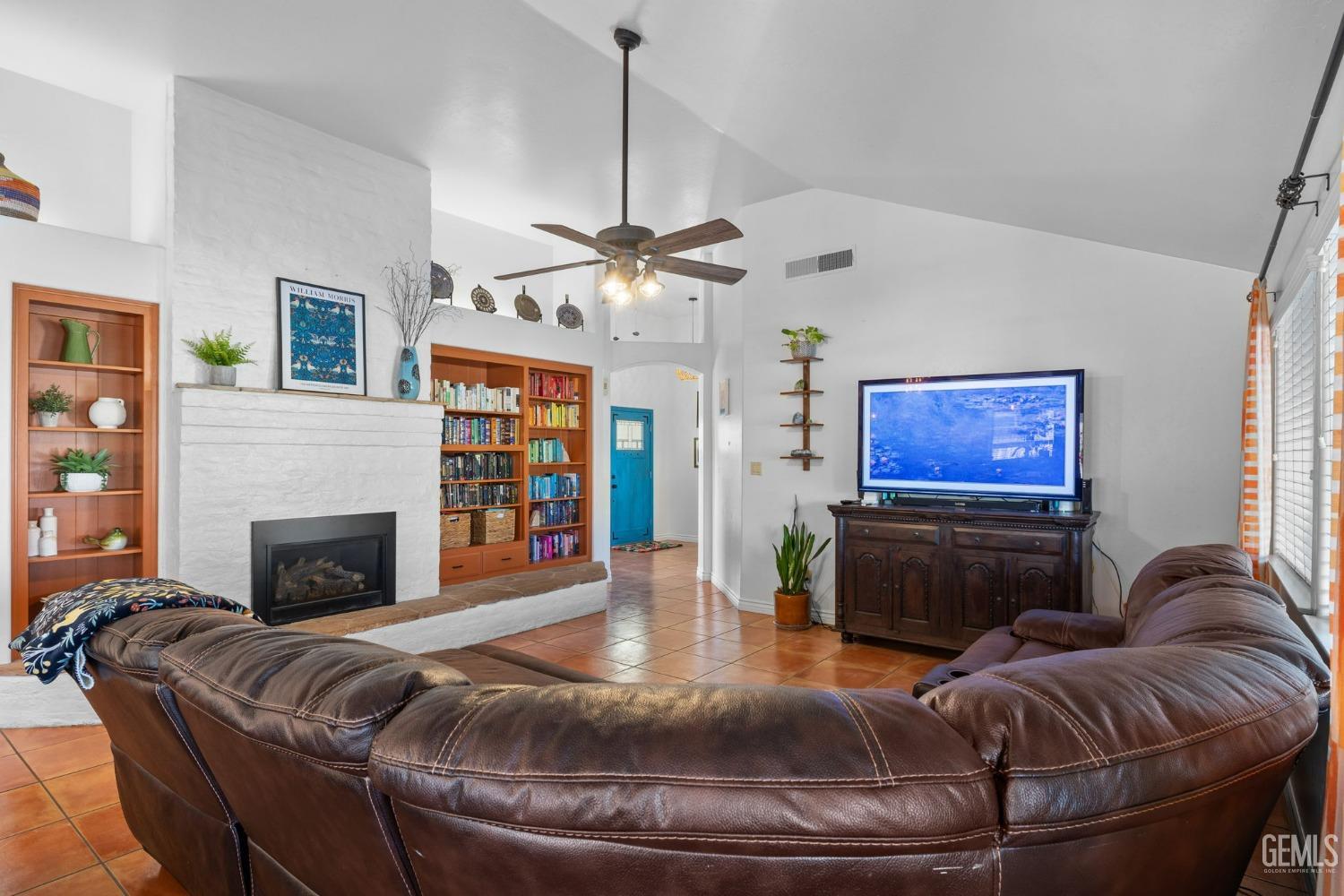 Undisclosed Address Bakersfield, CA 93311 - Photo 22 of 69 a living room with furniture a fireplace and a flat screen tv