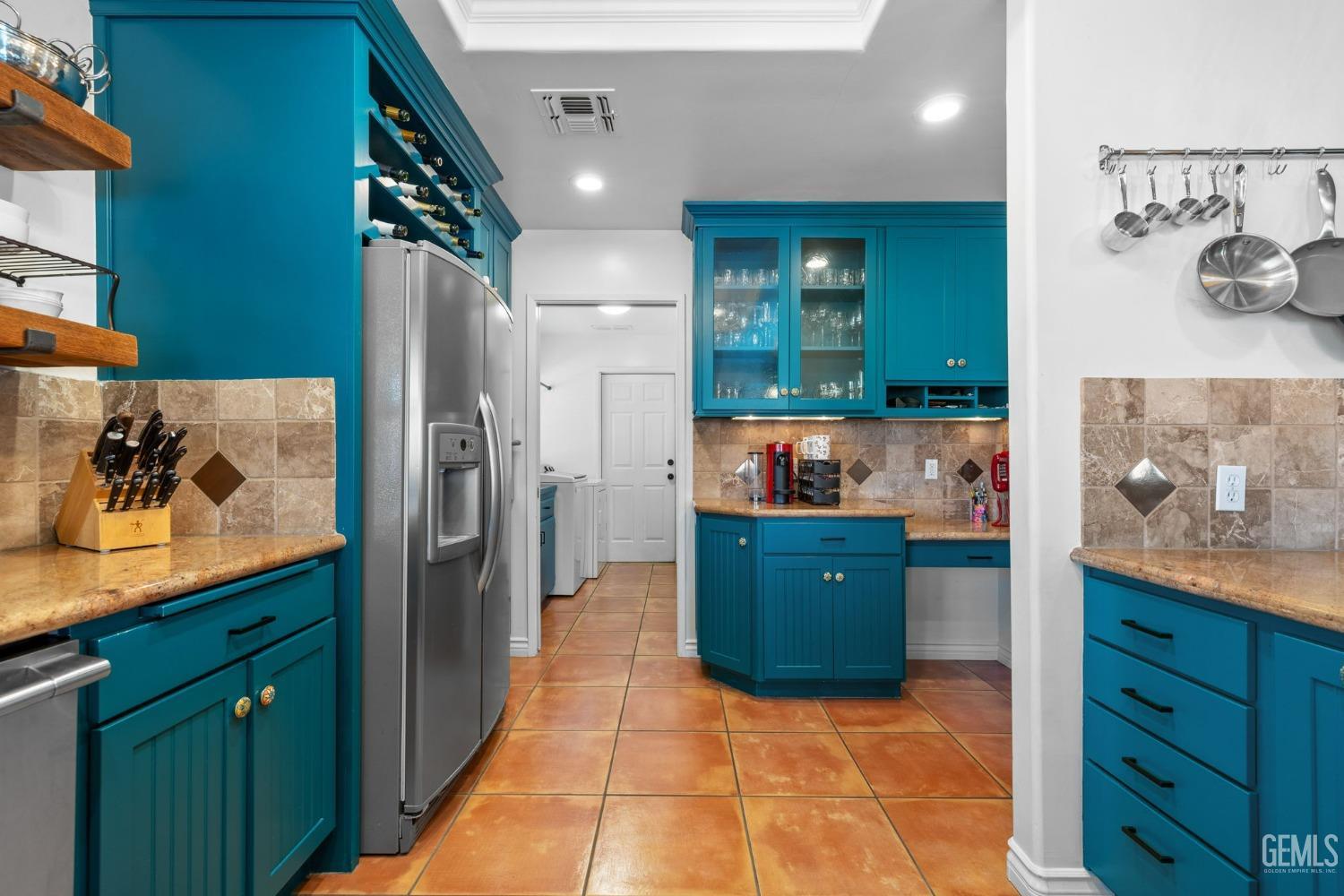 Undisclosed Address Bakersfield, CA 93311 - Photo 27 of 69 a kitchen with stainless steel appliances granite countertop a refrigerator and a wooden cabinets