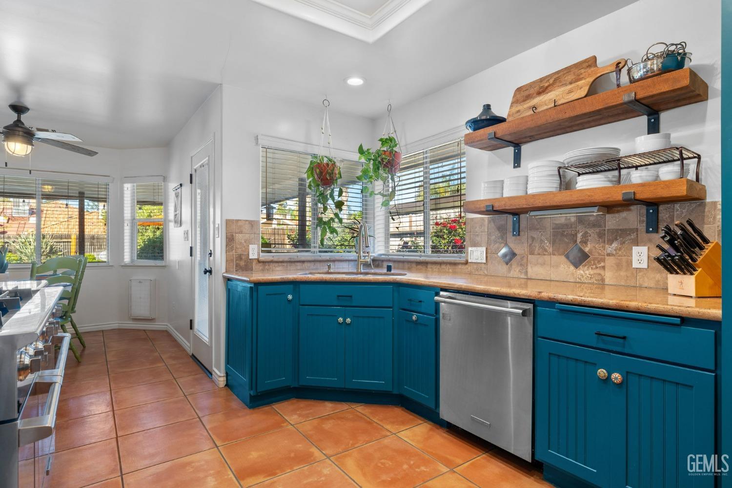 Undisclosed Address Bakersfield, CA 93311 - Photo 28 of 69 a kitchen with stainless steel appliances granite countertop a sink and wooden cabinets