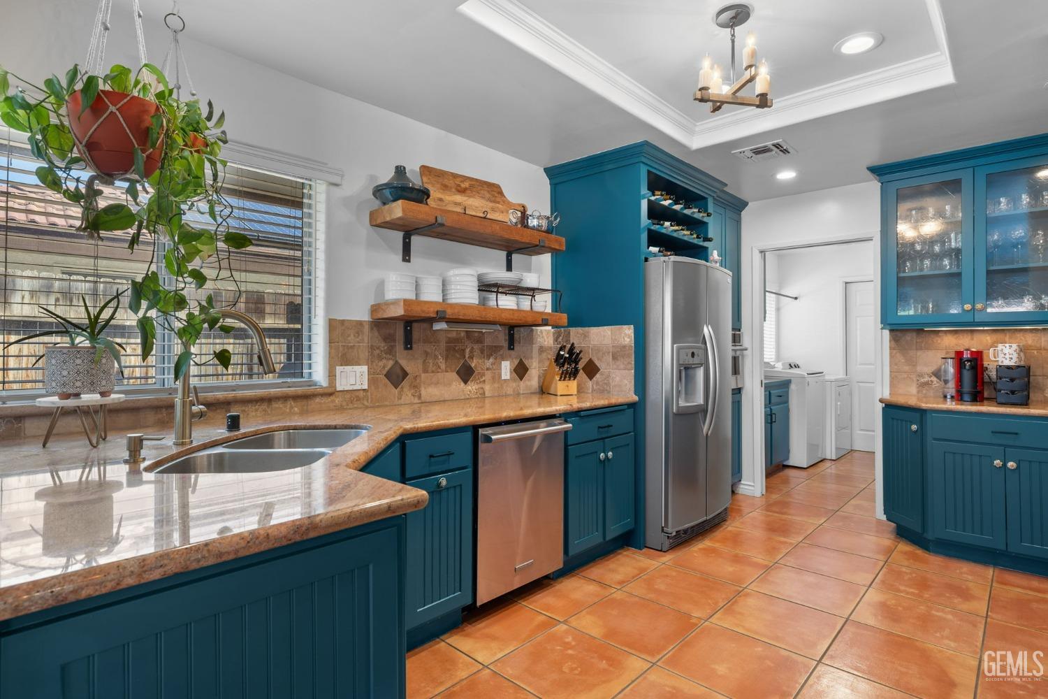 Undisclosed Address Bakersfield, CA 93311 - Photo 30 of 69 a kitchen with stainless steel appliances granite countertop a sink dishwasher and a refrigerator with wooden cabinets