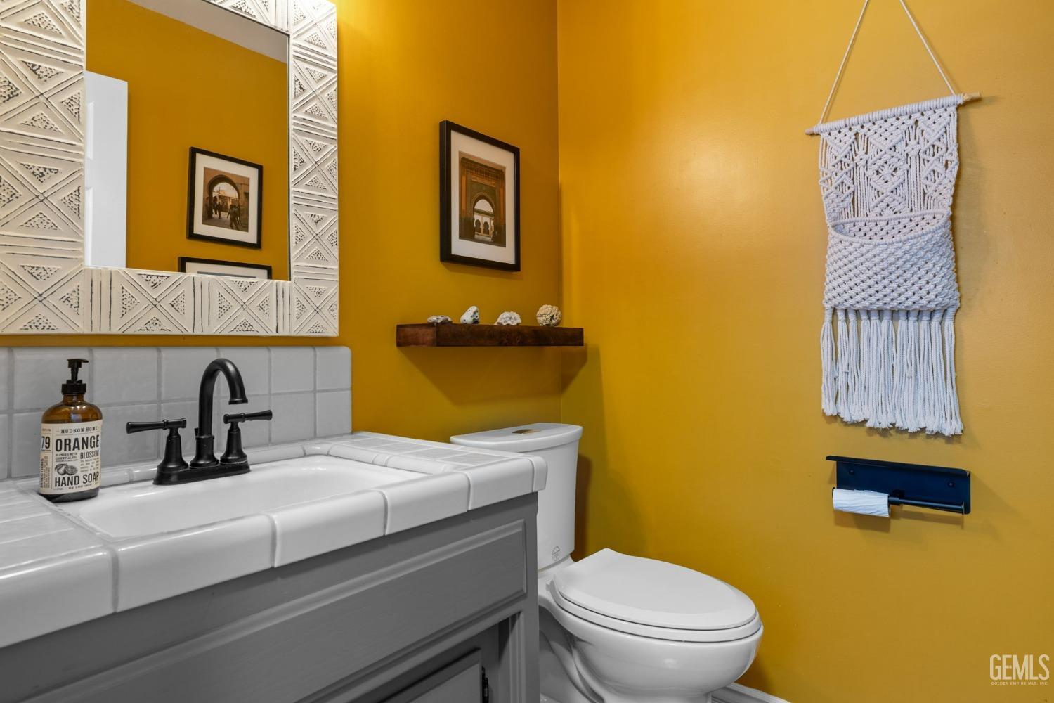 Undisclosed Address Bakersfield, CA 93311 - Photo 39 of 69 a bathroom with a sink a toilet and mirror