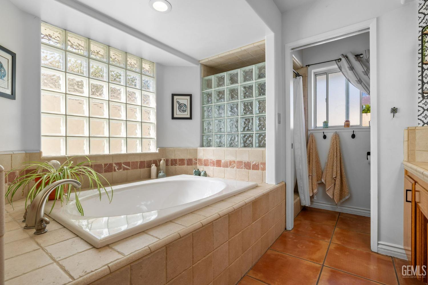 Undisclosed Address Bakersfield, CA 93311 - Photo 45 of 69 a spacious bathroom with a tub a sink and a window