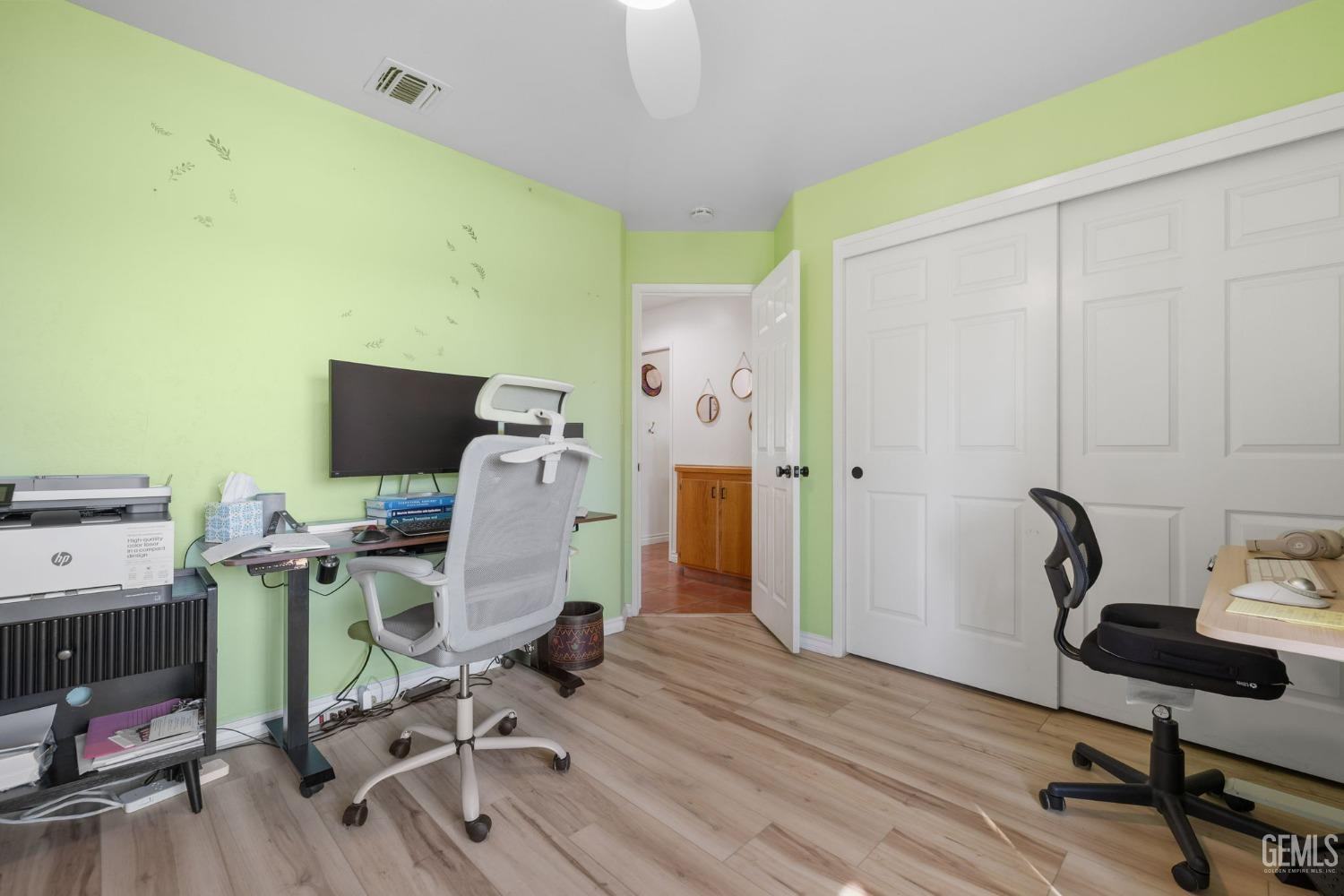 Undisclosed Address Bakersfield, CA 93311 - Photo 47 of 69 a view of a workspace with furniture and wooden floor