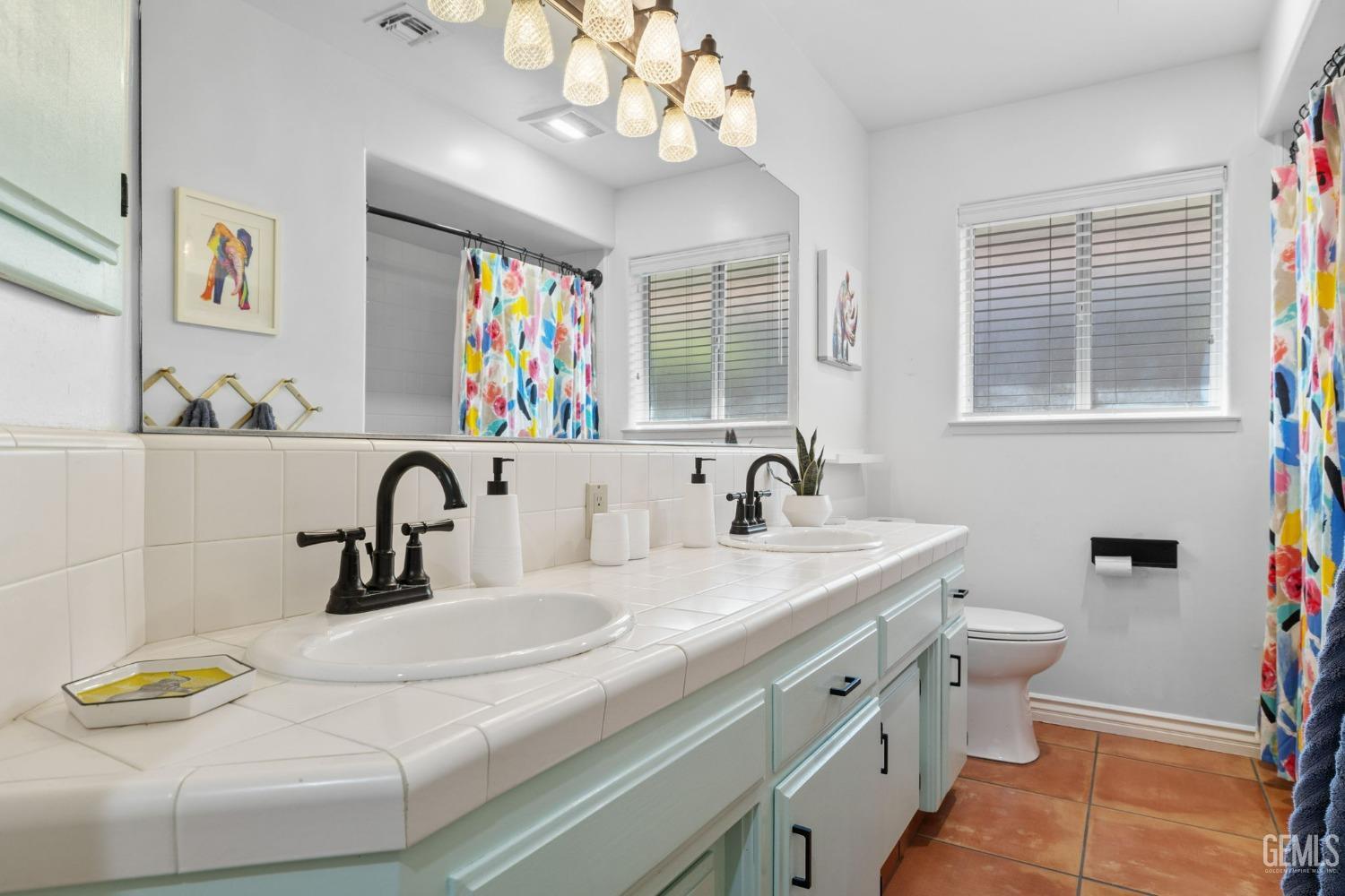 Undisclosed Address Bakersfield, CA 93311 - Photo 48 of 69 a bathroom with a sink a toilet and a mirror