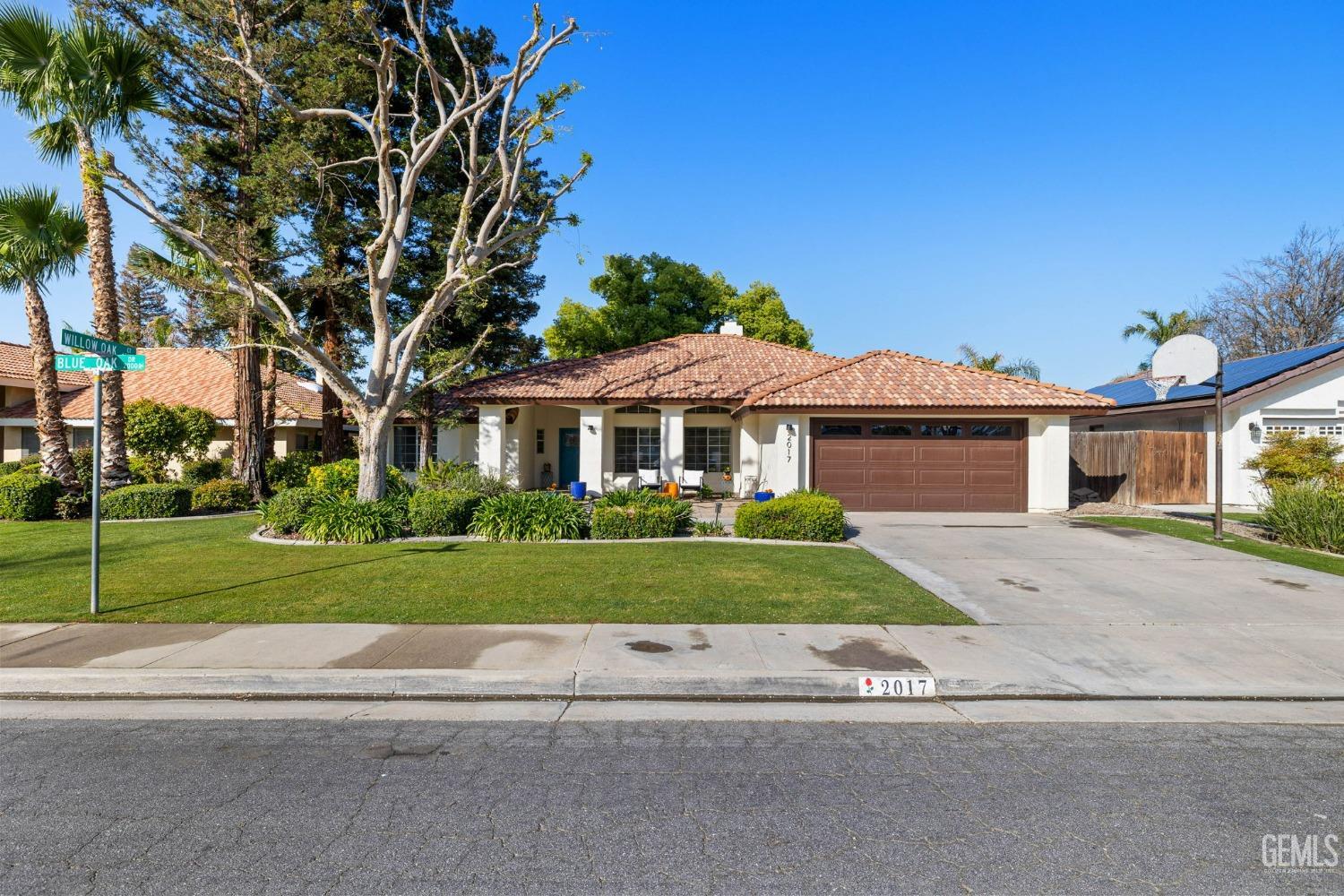 Undisclosed Address Bakersfield, CA 93311 - Photo 5 of 69 a front view of a house with a yard and garage